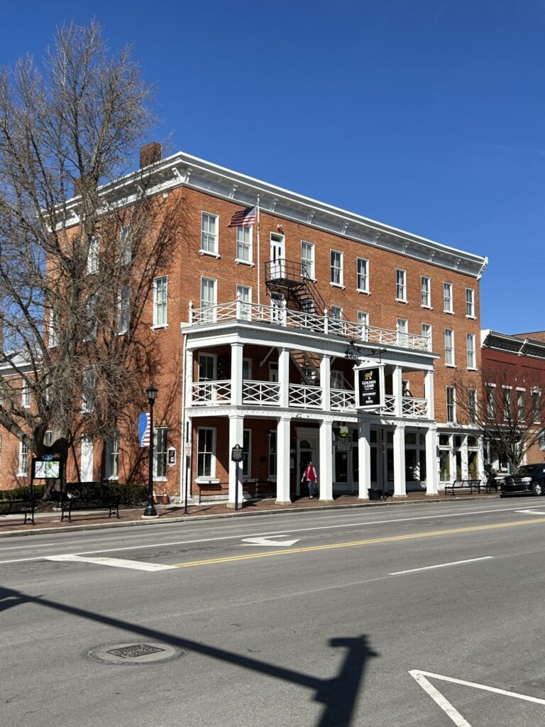 The historic red brick building and white multi-level balconies of The Golden Lamb hotel and restaurant in Lebanon, Ohio.