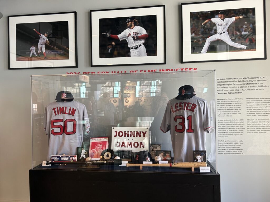 Historical memorabilia displays, World Series rings, and Red Sox Hall of Fame artifacts viewed during a Fenway Park tour.