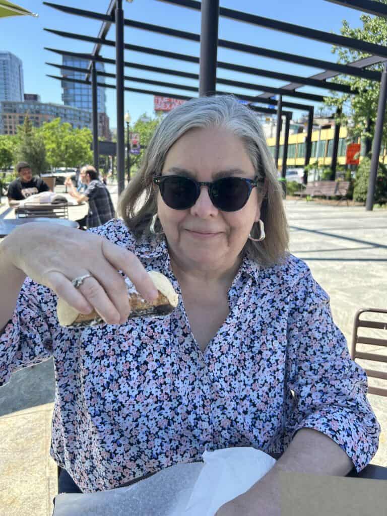 enjoying pastry at picnic table in north end park boston