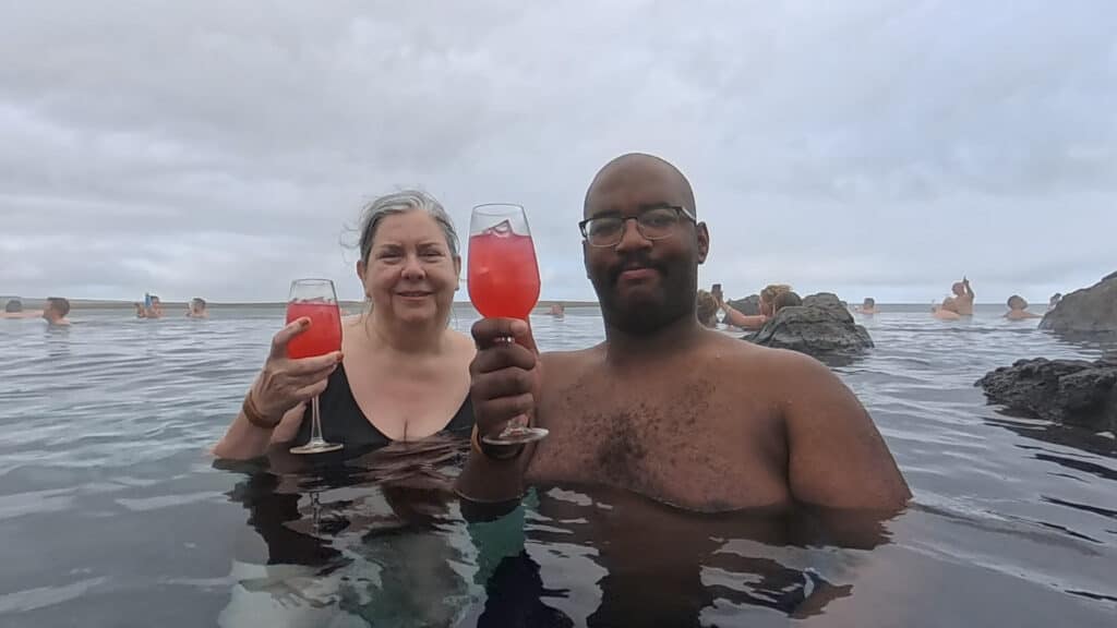 sky lagoon iceland family members with crowberry drinks at kopavogur